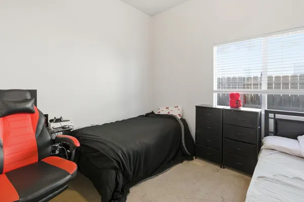 a bedroom with a bed and a window