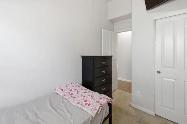a bedroom with a bed and a dresser