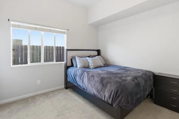 a bedroom with a bed and window