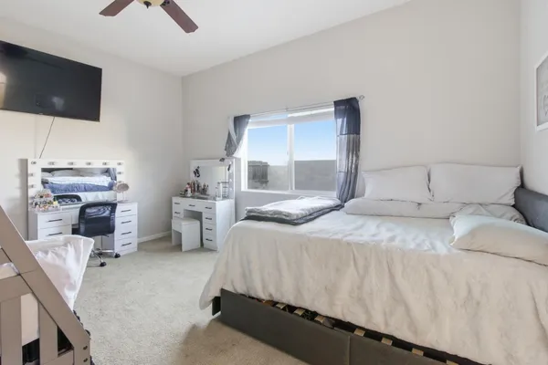 a bedroom with a bed and a flat screen tv