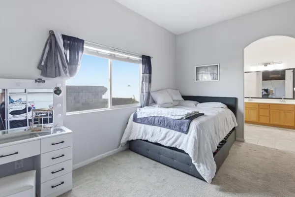 a bedroom with a bed and a dresser