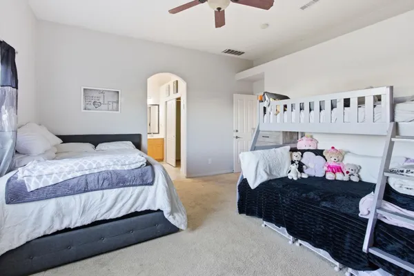 a bedroom with a bed and a chandelier