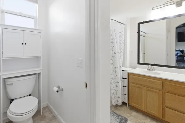 a bathroom with a toilet a sink and a mirror
