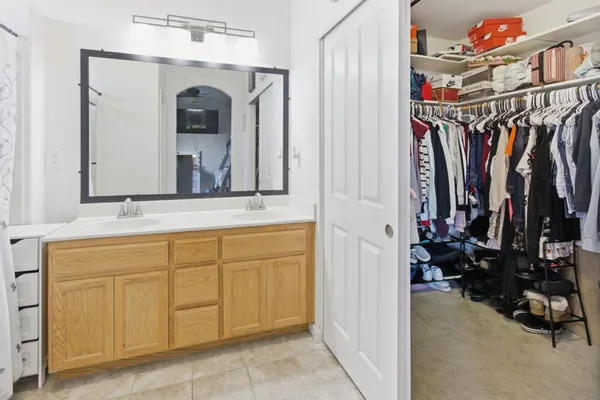 a view of walk in closet with clothes