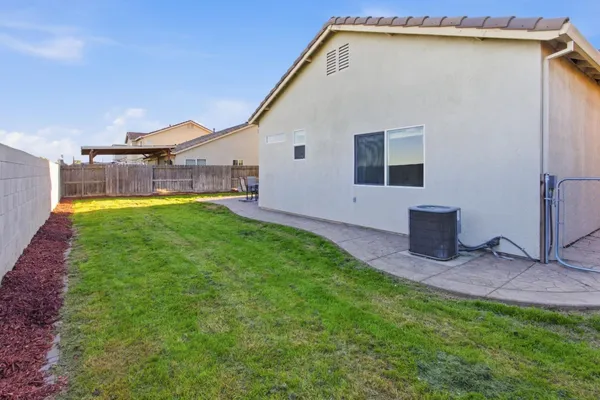 a backyard of a house with table and chairs