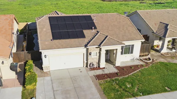 an aerial view of a house with backyard