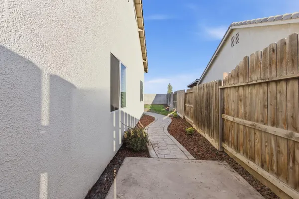 a view of a balcony with wooden floor and fence