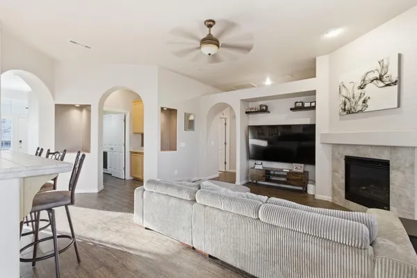 a living room with furniture a flat screen tv and a fireplace