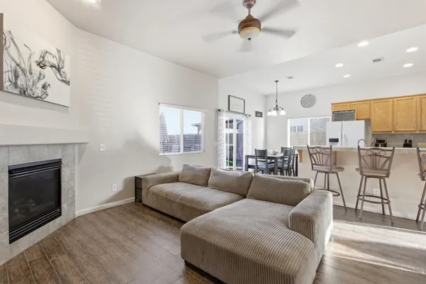 a living room with furniture kitchen view and a fireplace