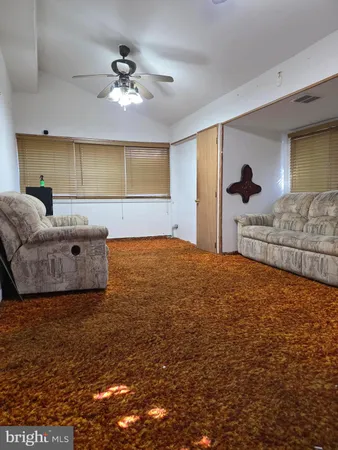 a bedroom with a bed and a ceiling fan