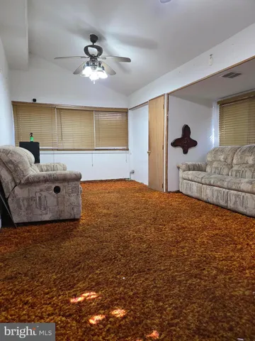 a bedroom with a bed and a ceiling fan