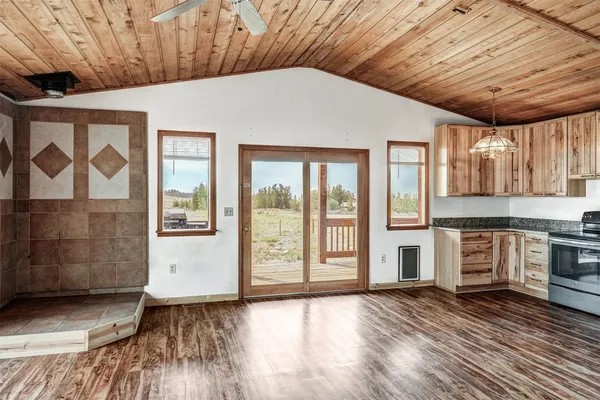 a view of a kitchen with a stove top oven and sink