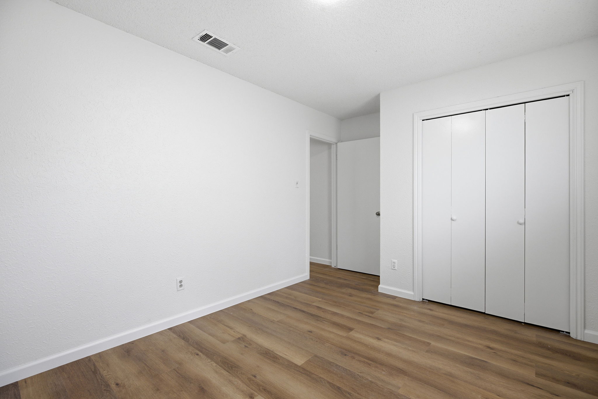 7205 Beckett Road Austin, TX 78749 - Photo 24 of 40 Rich wood flooring grounds this naturally illuminated room, complete with a convenient closet for storage.
