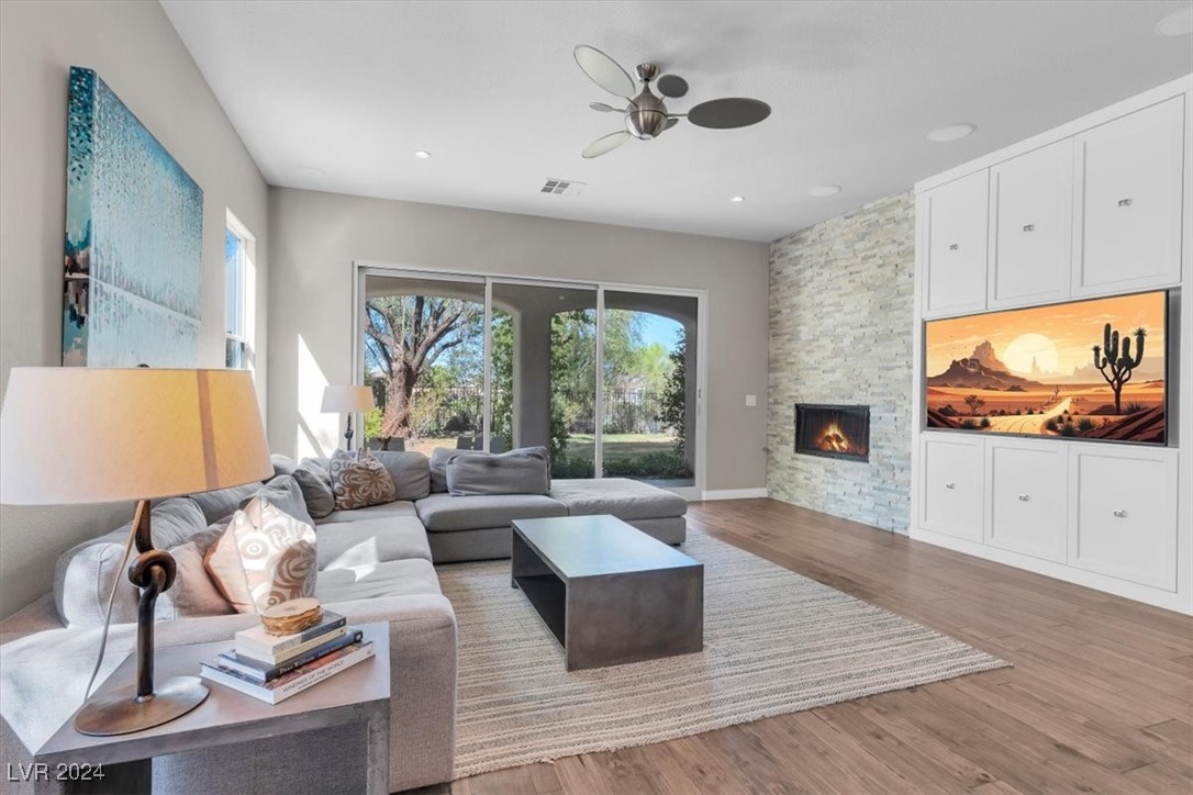 11348 La Madre Ridge Drive Las Vegas, NV 89135 - Photo 25 of 75 Great room featuring fireplace, entertainment shelving and surround sound. Featuring updated hardwood floors.