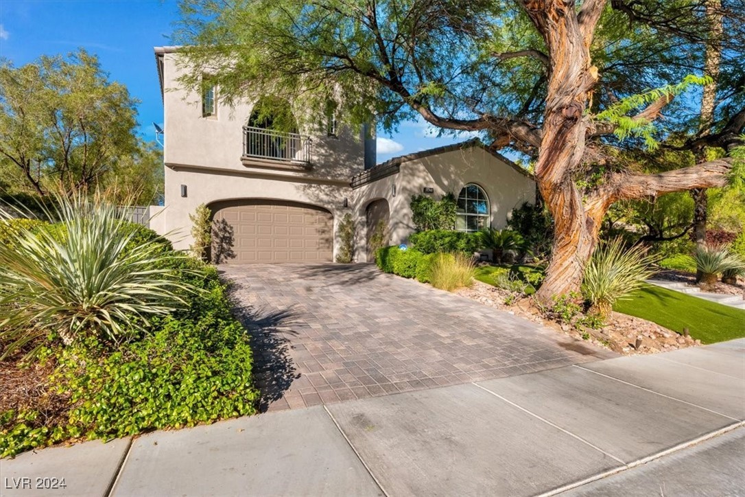 11348 La Madre Ridge Drive Las Vegas, NV 89135 - Photo 4 of 75 Impressive curb appeal with mature landscaping and three car garage.