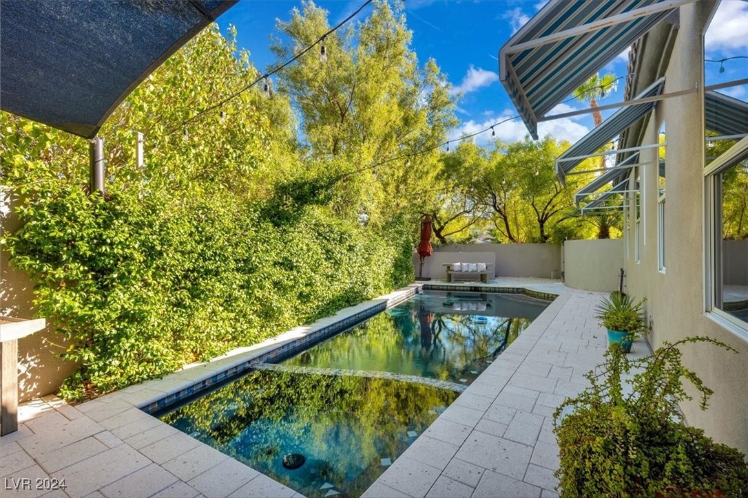 11348 La Madre Ridge Drive Las Vegas, NV 89135 - Photo 5 of 75 Secluded Pool & Spa with updated tile, shellock paver decking & sun shade sail patio.
