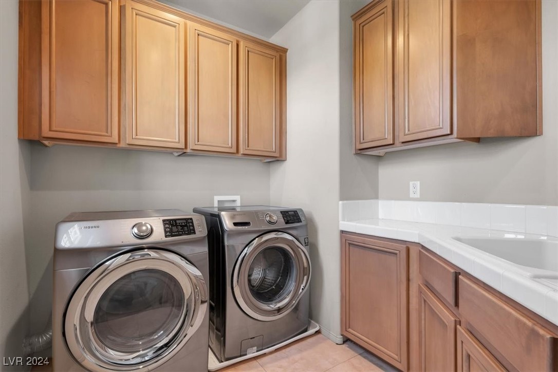 11348 La Madre Ridge Drive Las Vegas, NV 89135 - Photo 57 of 75 Second floor laundry room with cabinets and sink.