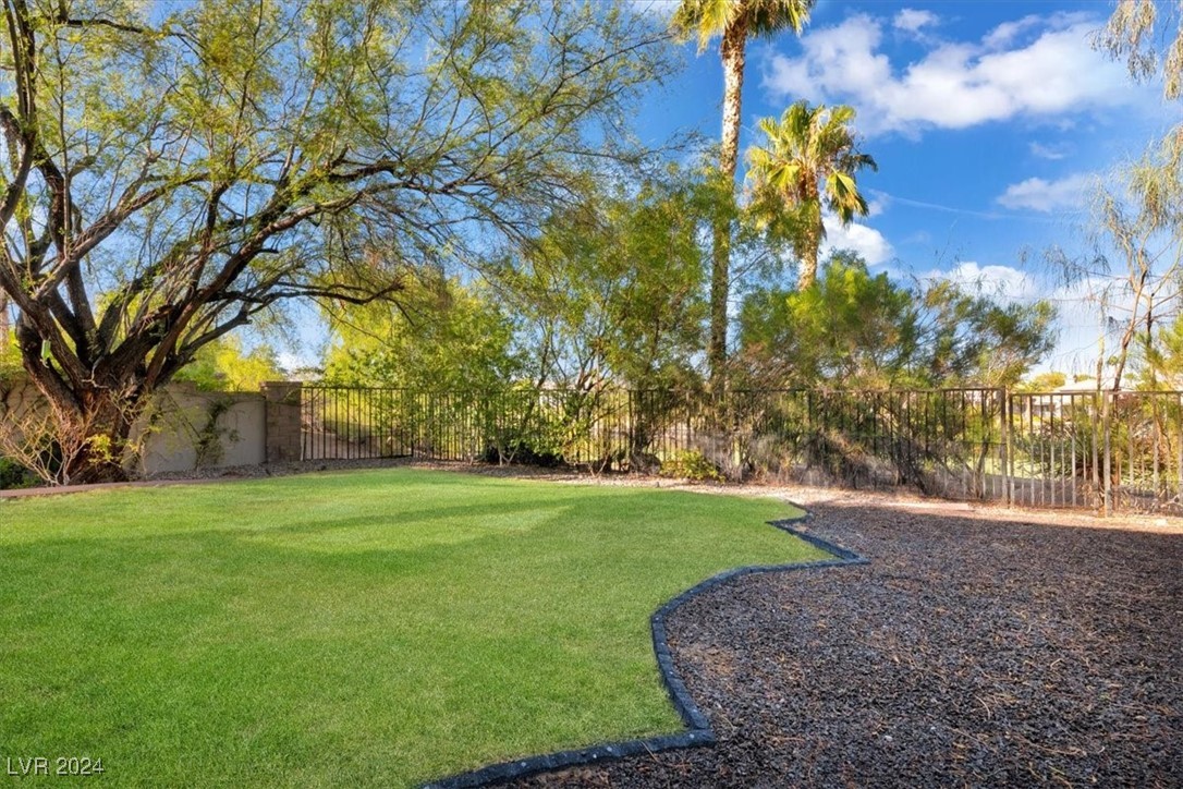 11348 La Madre Ridge Drive Las Vegas, NV 89135 - Photo 61 of 75 One of the largest lots in guard gated Red Rock Country Club East. On the private Mountain Course with view fence looking at the 10th hole and lake. An entertainer's dream with several distinct backyard areas and mature landscaping.
