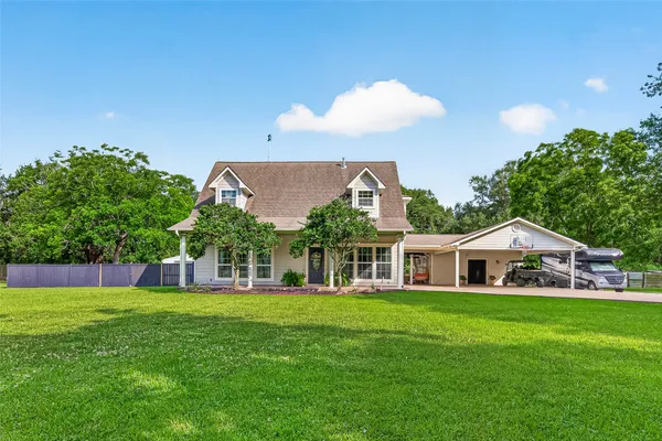 a view of a house with a yard and sitting area