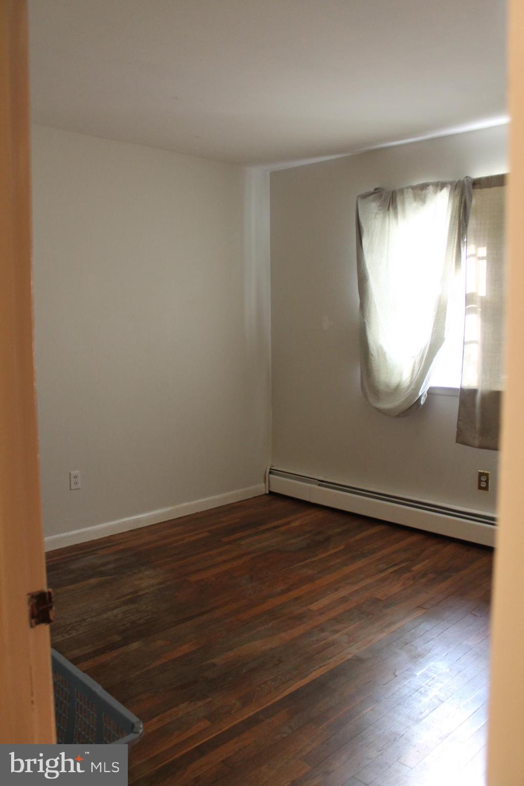 26 Taunton Road Medford, NJ 08055 - Photo 15 of 24 an empty room with wooden floor and windows