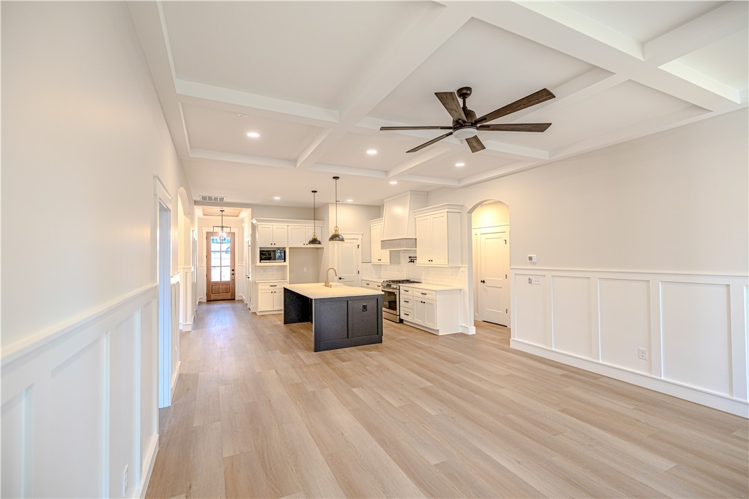 1409 Stonehurst Road Anderson, SC 29621 - Photo 32 of 37 This bright, open-concept living space features a modern kitchen and inviting hardwood flooring.