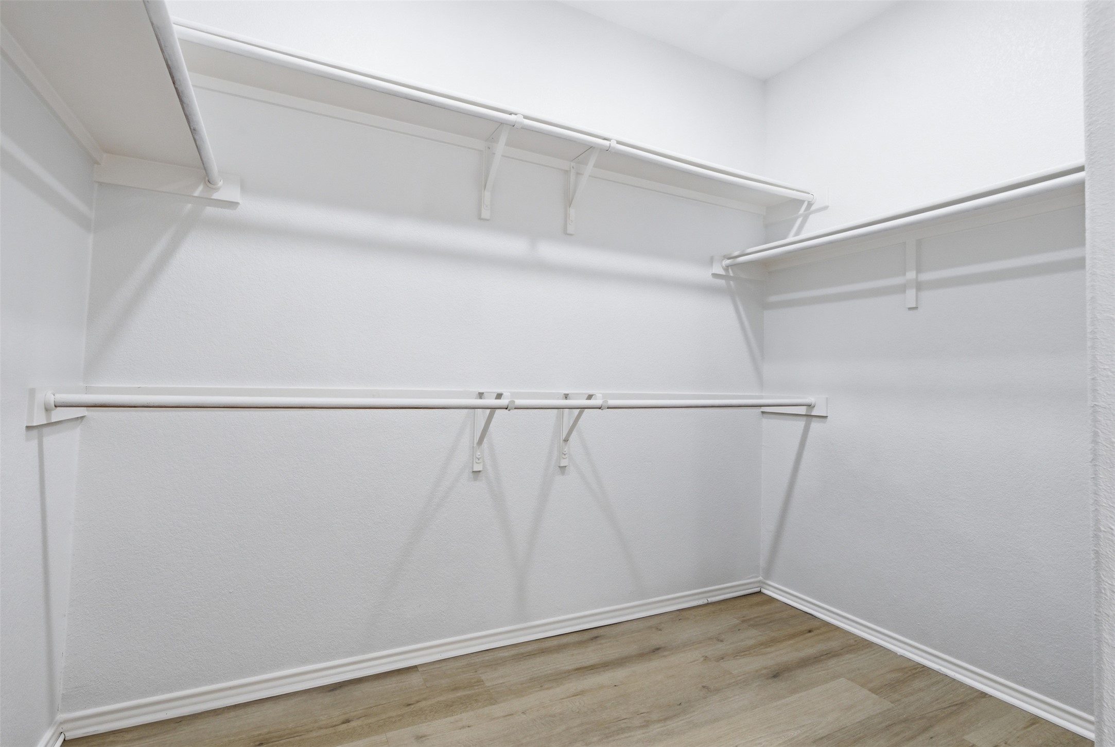 461 Hot Spring Valley Buda, TX 78610 - Photo 14 of 25 Walk-in closet featuring white wire shelving, hanging rods, and light wood-look flooring