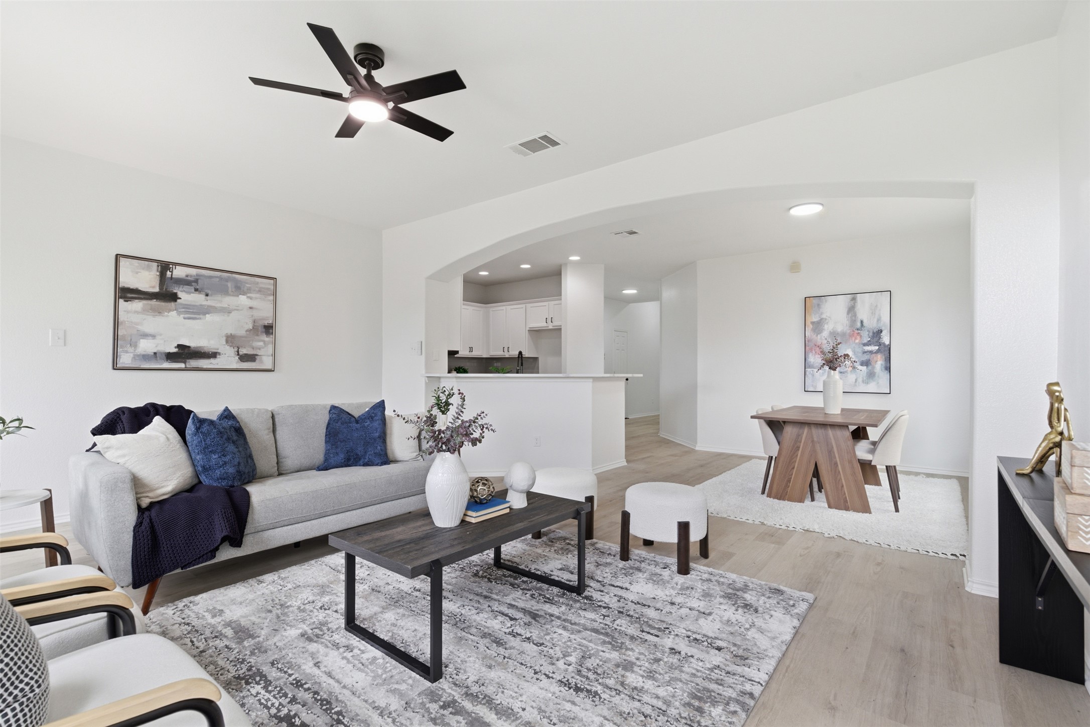 461 Hot Spring Valley Buda, TX 78610 - Photo 5 of 25 The living area features light-colored flooring, a ceiling fan with integrated lighting, and white walls