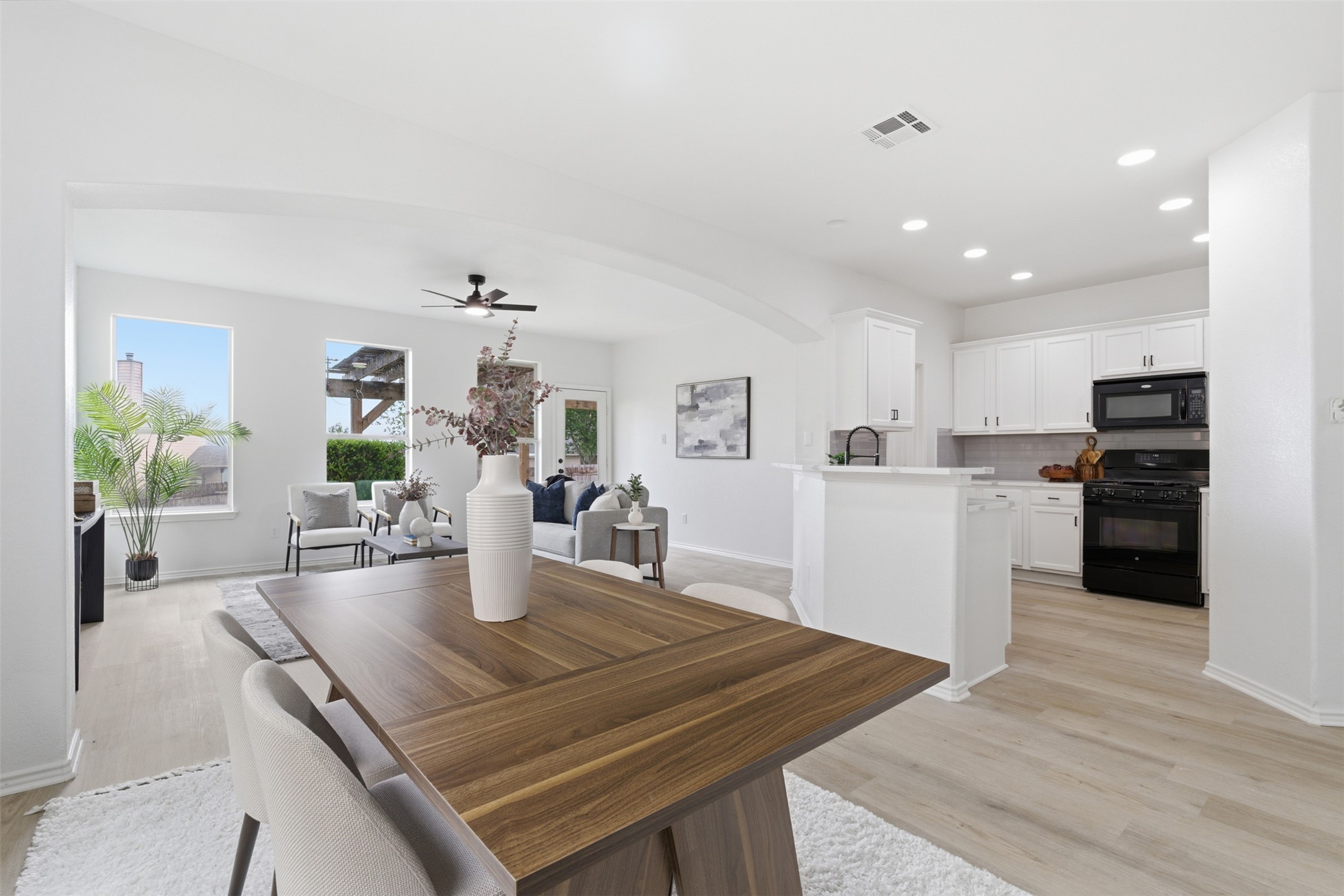 461 Hot Spring Valley Buda, TX 78610 - Photo 8 of 25 Open concept living space featuring light-colored flooring, white walls, and recessed lighting