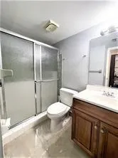 a bathroom with a sink toilet and shower