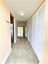 7300 Northwest 5th Court, Unit 106 Margate, FL 33063 - Photo 3 of 13 a view of entryway with wooden floor