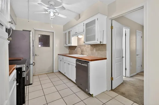 a view of a kitchen with furniture and a refrigerator