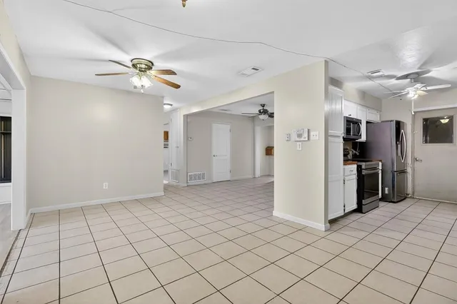 a living room with furniture a flat screen tv and a large window