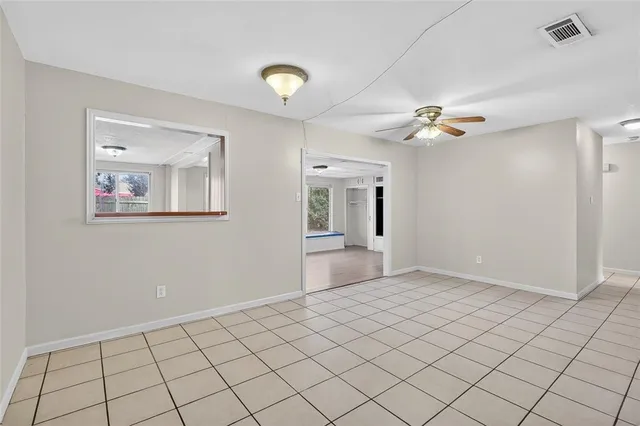 a living room with furniture a fireplace and a large mirror