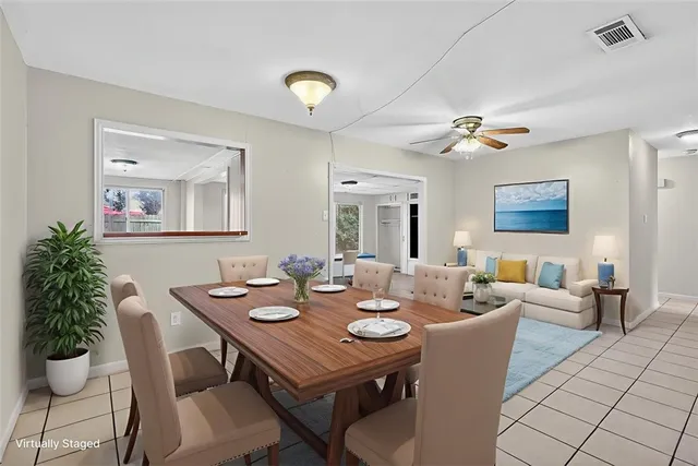 an empty room with a window and ceiling fan