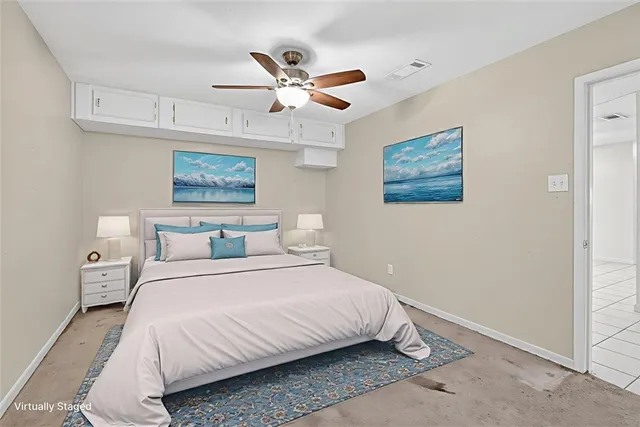 a bedroom with a bed and a painting on the wall