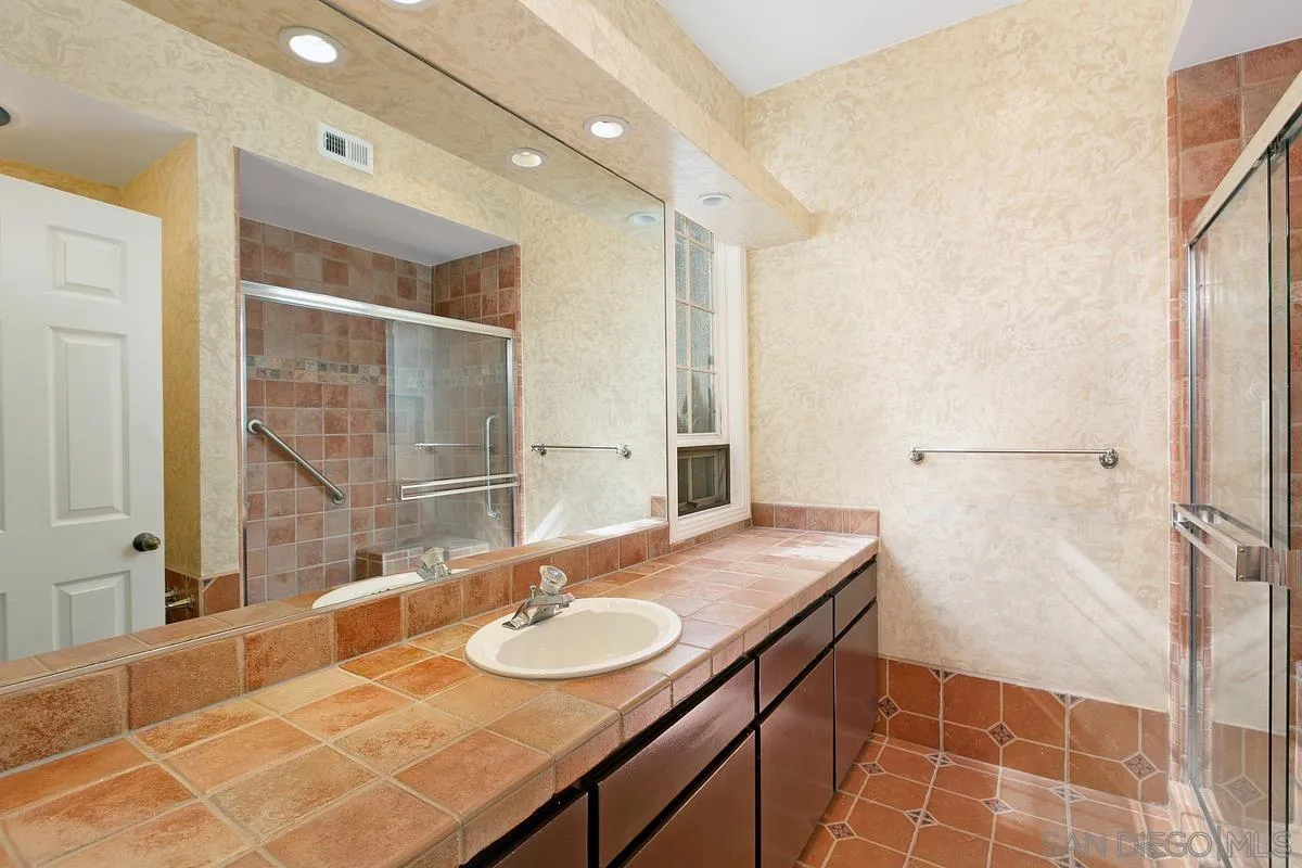 3919 Pringle Street San Diego, CA 92103 - Photo 21 of 37 a bathroom with a sink and a mirror
