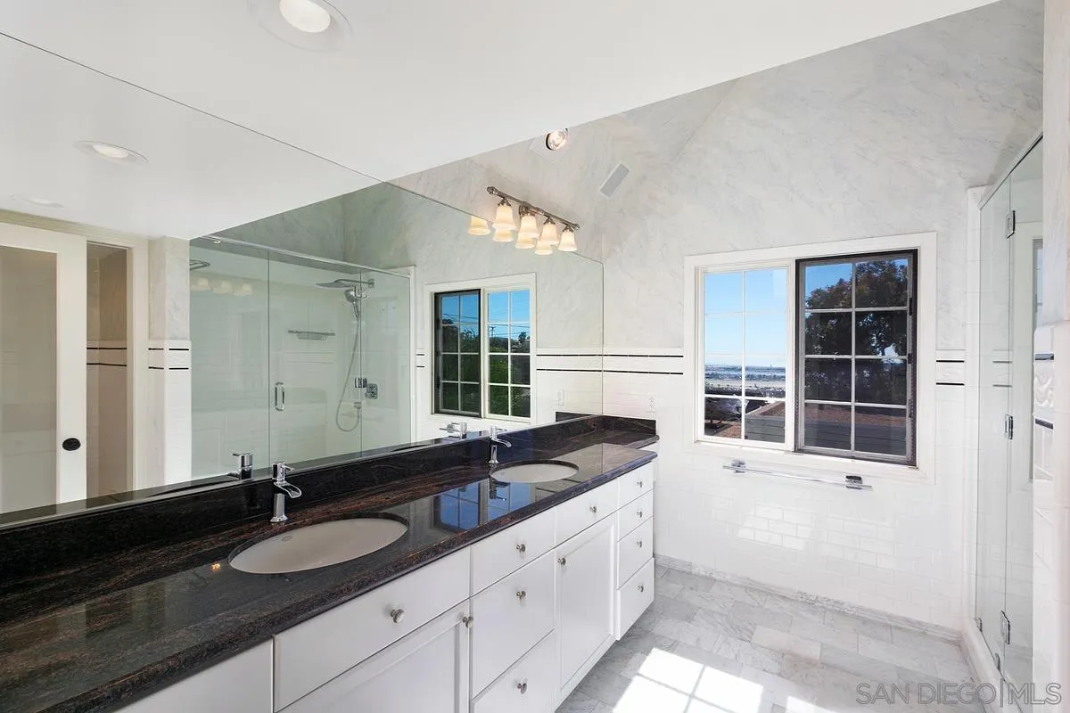 3919 Pringle Street San Diego, CA 92103 - Photo 28 of 37 a bathroom with a granite countertop sink and large mirror