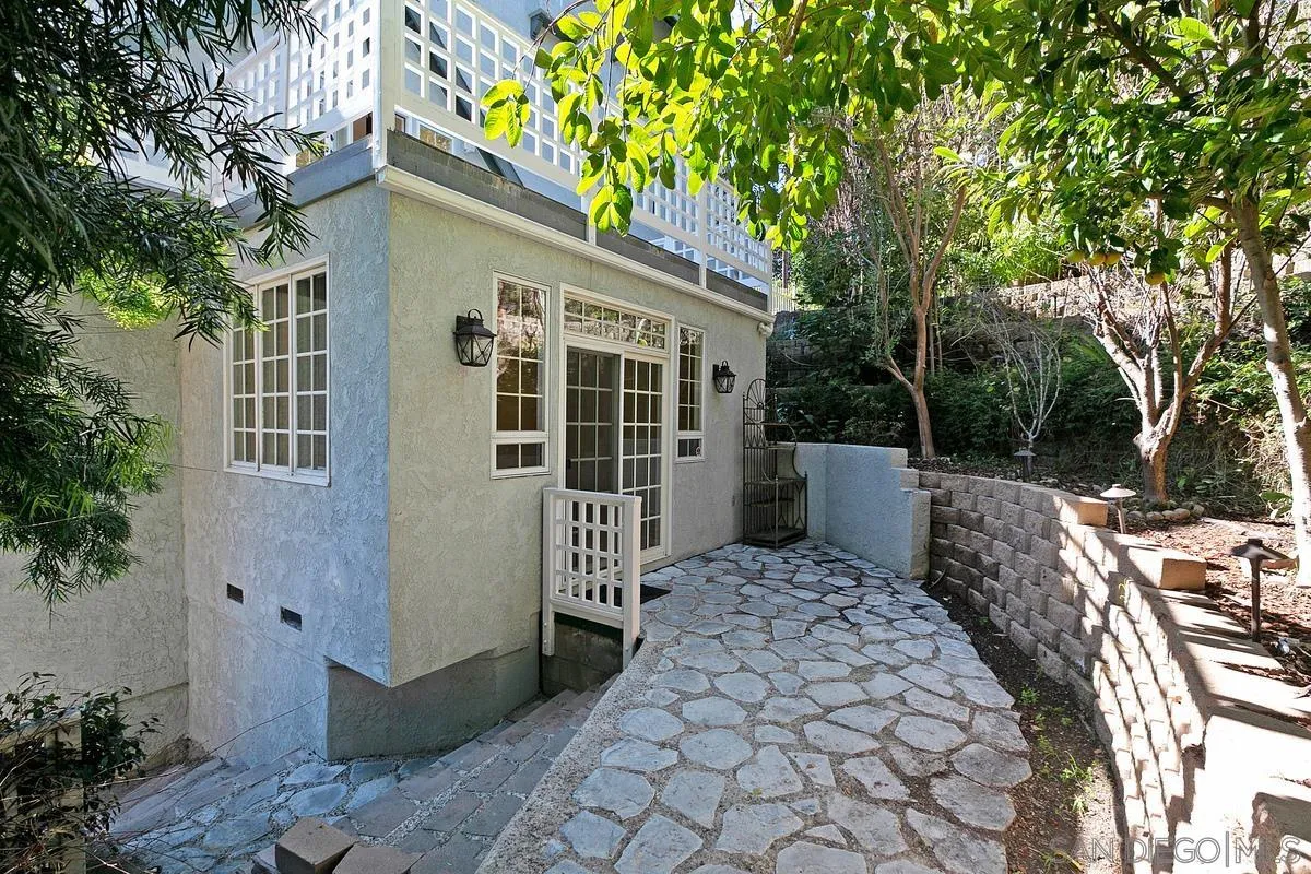 3919 Pringle Street San Diego, CA 92103 - Photo 32 of 37 a view of a house with a small yard and wooden fence