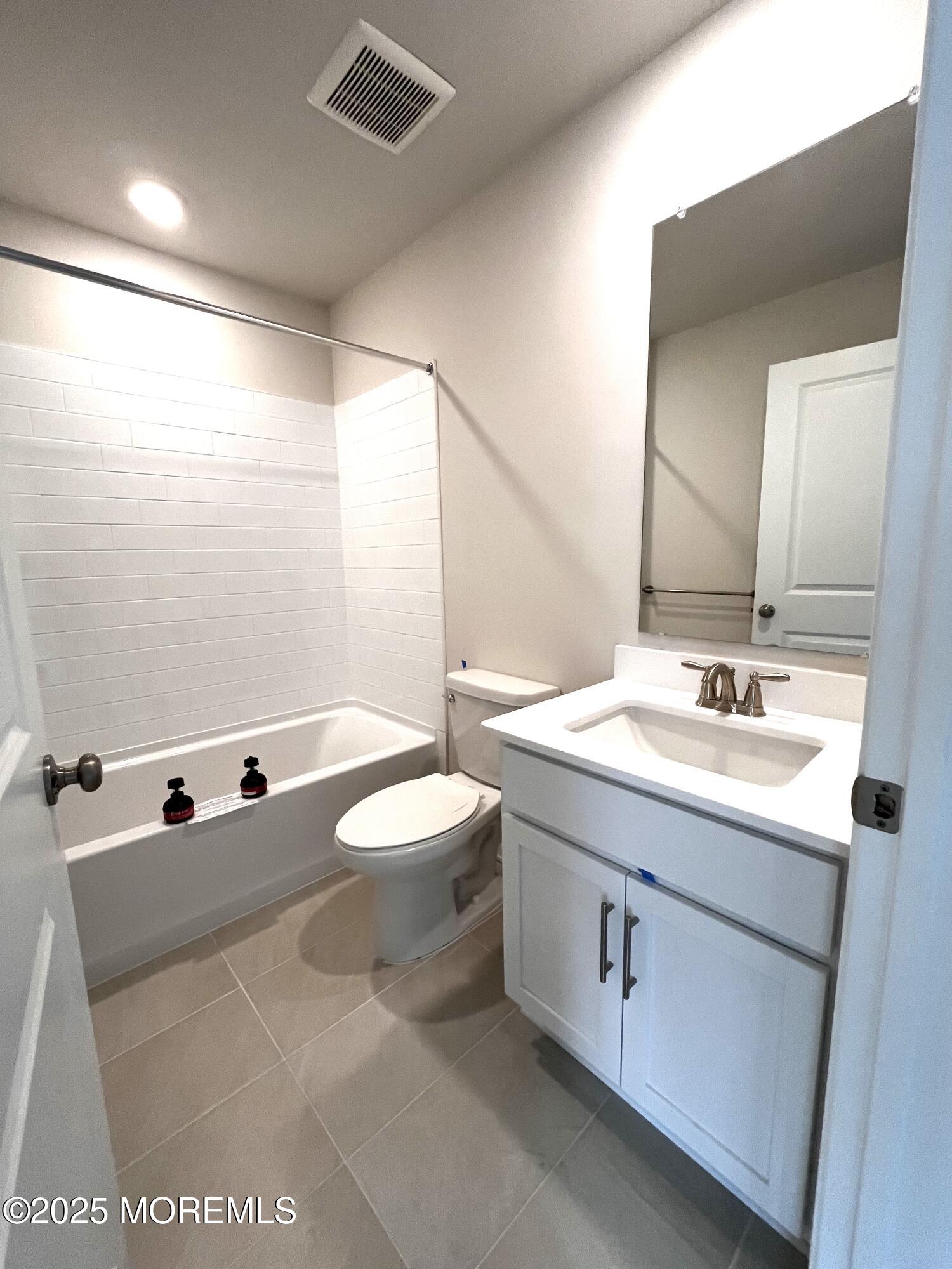 14 Rothbury Court Tinton Falls, NJ 07753 - Photo 28 of 28 a bathroom with a sink a toilet and a mirror