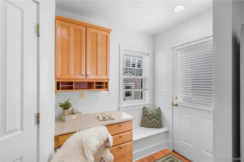 a view of a hallway with workspace and a couch