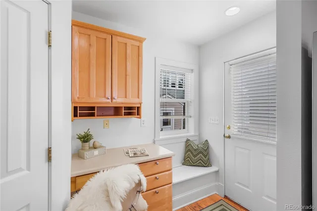 a view of a hallway with workspace and a couch