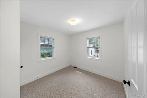 a view of house with a deck and furniture