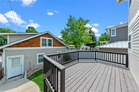a view of a house with a yard and sitting area