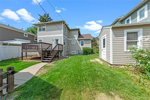 a view of a house with a yard and garage