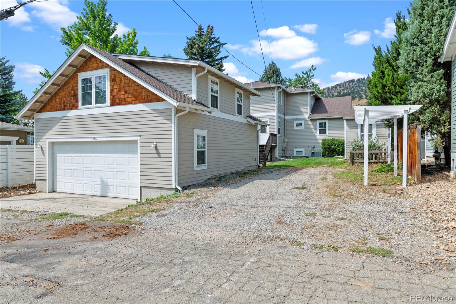 3056 8th Street Boulder, CO 80304 - Photo 28 of 45 a view of a house with a yard and garage