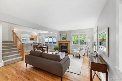 a living room with fireplace furniture and a wooden floor