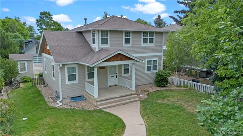 an aerial view of multiple houses with yard