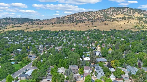 an aerial view of a house with garden space and street view