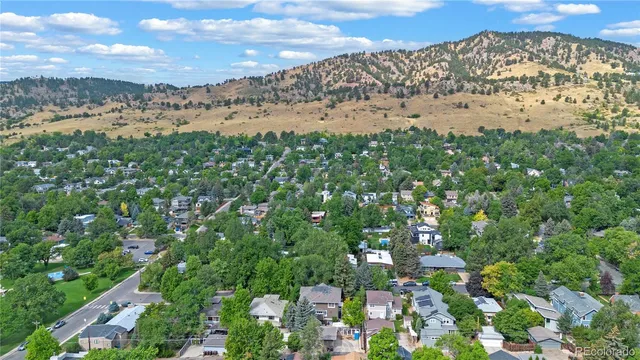an aerial view of a house with garden space and street view