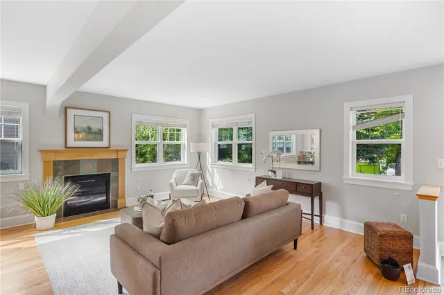 a living room with furniture a lamp and a large window